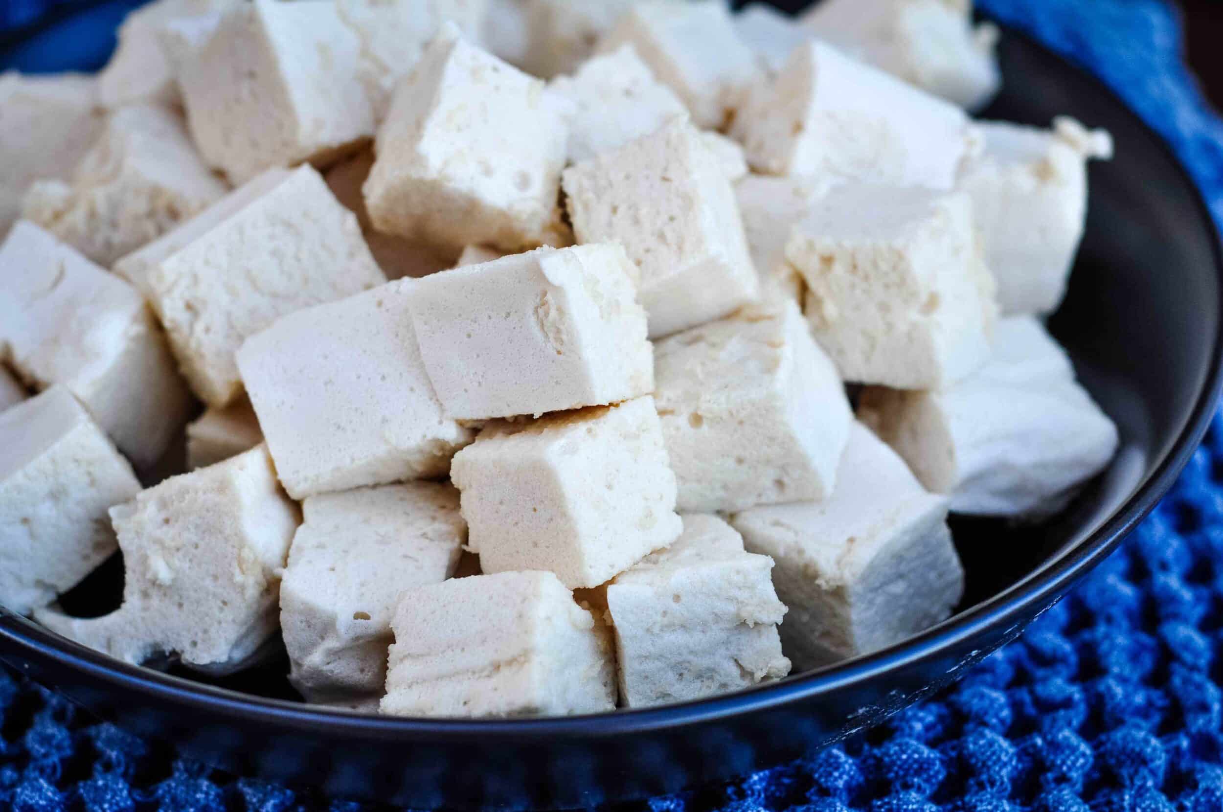 Homemade marshmallows with marshmallow root in a large dark bowl.